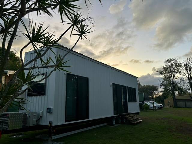 10m Tiny Home on Wheels — Ground-Floor Bedroom, Loft Sleeping + Triple Sliding Doors - Image 1