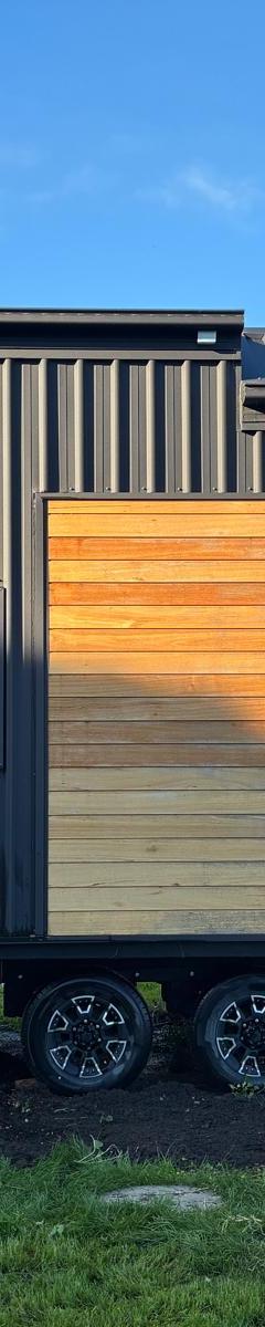 Honey Timber & Black 8.4m Tiny Home on Wheels — Wood Fireplace & Loft Bedroom thumbnail 1